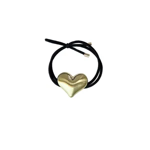Minimalist black elastic hair rope featuring a polished golden alloy heart charm