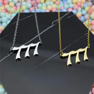 Close-up of stainless steel 777 angel number pendants in gold and silver finishes.
