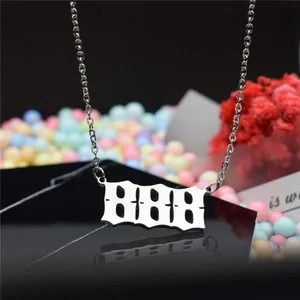 Detailed view of a silver stainless steel necklace with 888 angel number pendant
