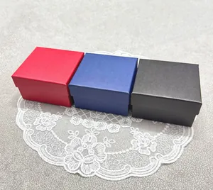 Macro view of three textured square jewelry gift boxes in red, blue, and black colors