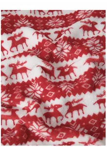 Gros plan sur la texture du tissu en flanelle avec imprimé renne de Noël rouge et blanc
