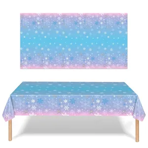 Detail view of snowflake pattern on blue and pink gradient party tablecloth.
