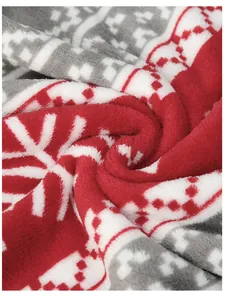 Close-up detail showing the texture of soft red and white Christmas printed flannel fabric
