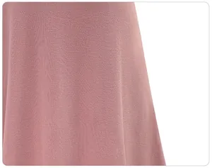 Macro close-up detail showing the soft pink fabric texture of the mid-length skirt