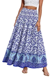 Detail of bohemian high-waisted maxi skirt with blue floral print and smocked waist