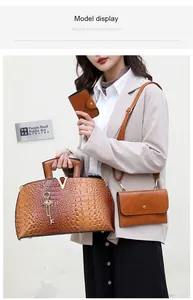 Elegant model holding crocodile pattern handbag set in brown finish and stylish blazer
