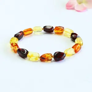 Macro view of natural multi-color amber bracelet with irregular shaped beads