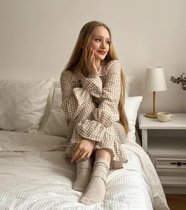Elegant brown gingham cotton pajama set for women featuring ruffle cuff details in bedroom