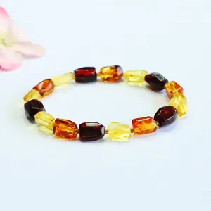 Close-up of multi-colored natural amber bracelet with gold and blood amber beads.