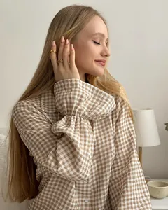 Detailed look at the stylish ruffled cuff on a brown and white gingham pajama top