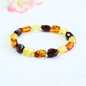 Detailed shot of multi-color amber bead bracelet featuring natural honey and blood stones