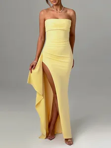 Detailed view of an elegant yellow strapless bodycon maxi dress with a high side slit