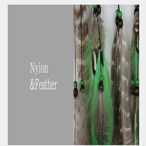 Detailed view of handmade forest-themed dreamcatcher with green feathers and wood beads