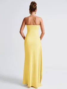Back view of a sexy yellow strapless tube maxi dress for women in stylish summer fashion
