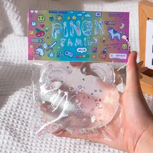 Detail view of a transparent pig squishy toy with glitter and iridescent heart sequins.