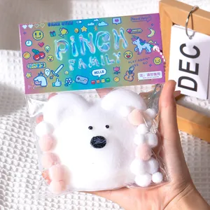Soft plush white puppy decompression pinch toy with colorful cartoon theme packaging