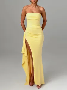 Full length view of yellow strapless maxi dress with sexy high side slit and drapes