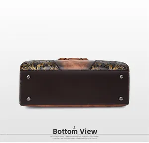 Bottom view details of a vintage embossed leather handbag featuring protective metal rivets