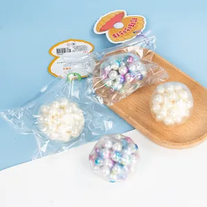 Colorful pearl squeeze balls stress relief toys in shell themed packaging.