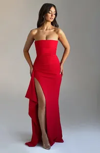 Elegant red strapless evening gown featuring a sexy high side slit and ruffled detail