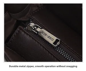 Close-up detail of sturdy metal zipper pull on retro embossed leather handbag