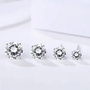 Close-up of four different sizes of minimalist sterling silver cubic zirconia stud earrings