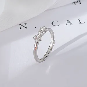 Detailed macro shot of a S925 silver bow-knot ring with a minimalist sleek design