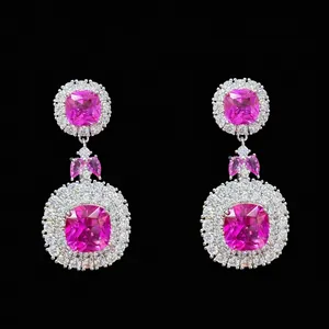 Detailed close-up of luxurious long earrings featuring pink square-cut gemstones and sparkling zircons.