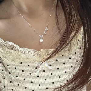 Detail view of a S925 sterling silver butterfly necklace with a Moissanite stone pendant.