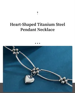 Close-up of a silver titanium steel heart pendant necklace with bead links