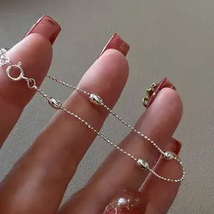 Dettaglio in primo piano di un braccialetto in argento sterling 925 con perle a oliva