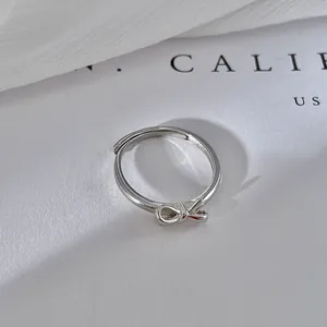 Detailed view of a minimalist S925 silver bow ring with adjustable band.