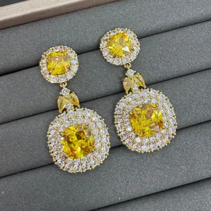 Elegant long drop earrings with yellow cushion-cut crystals and halo detail.