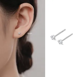 Detail shot of 4mm 999 sterling silver zircon stud earrings on model's ear