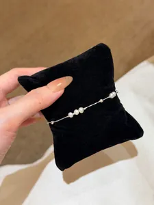 Close-up of a delicate S925 sterling silver bracelet with freshwater pearls