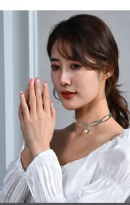 Elegant silver heart pendant choker shown on model for a minimalist aesthetic look.
