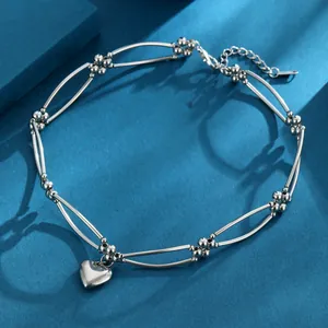 Elegant silver-toned heart pendant necklace featuring a unique bead and bar chain design.
