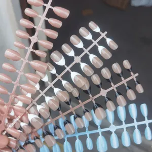 Detailed view of handmade almond press-on nails in various French tip styles