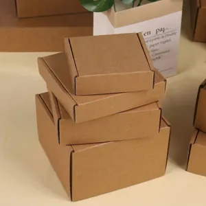 Stack of various sized brown kraft paper square corrugated mailing boxes for shipping