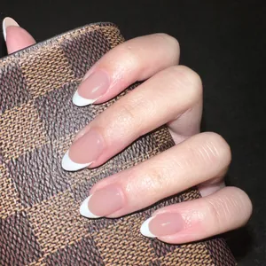 Realistic handmade almond press-on nails featuring a classic white French tip design.
