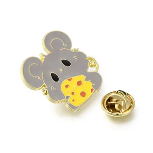 Close-up detail of a cute cartoon gray mouse holding yellow cheese enamel pin brooch