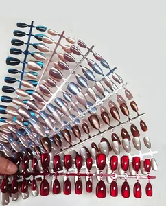 Detail showing various colors of short almond press-on nails with metallic finish.