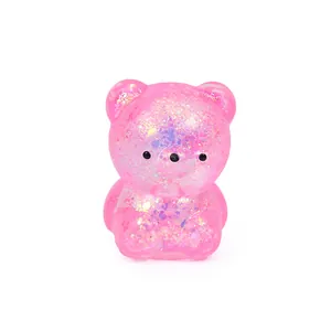 Close-up detail of a pink translucent bear squishy toy filled with colorful sequins