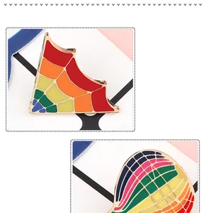 Close-up of creative rainbow enamel pins with hot air balloon and geometric designs.