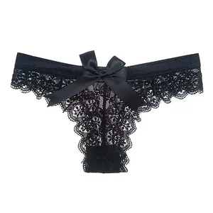 Detailed macro view of a sexy black lace thong featuring a large decorative satin bow