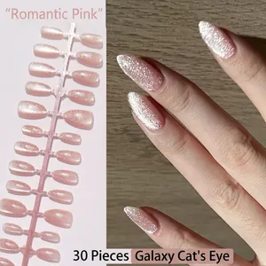 Close-up detail of pink starry sky cat-eye glitter press-on nails and applied look