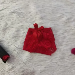 Detailed view of red sexy lace hollow-out panties with a large bow