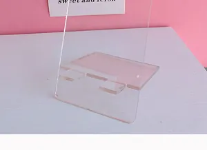 Close-up of a minimalist transparent acrylic phone stand on a white desk