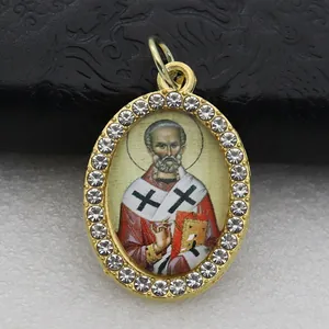Exquisite detail of oval religious saint pendant with micro-paved crystal rhinestones