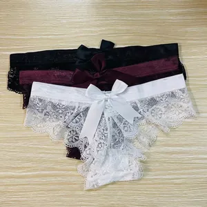 Close-up detail of three sexy lace panties featuring elegant silk bows in black, red, and white.